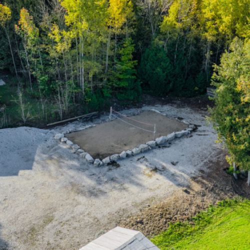 A sand volleyball court providing a fun activity for guests, with plenty of open space for other outdoor games and activities.