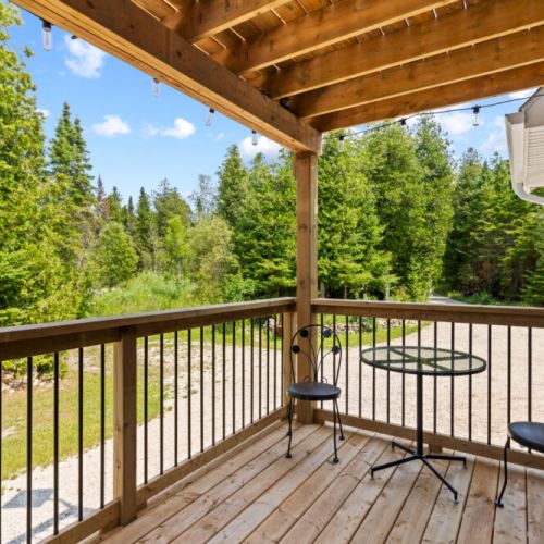 Enjoy a peaceful outdoor seating area overlooking the tranquil woodland setting.