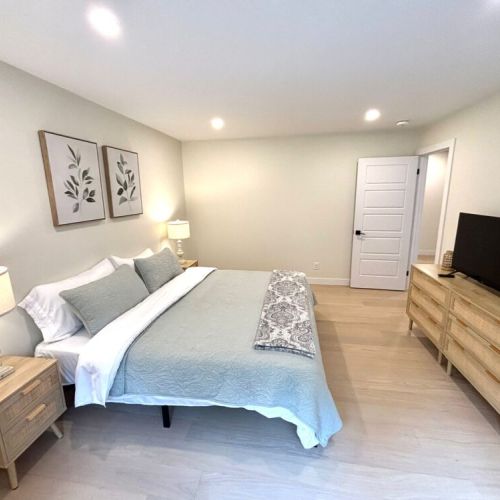 Sleep like royalty in the serene king suite – featuring clean modern lines, soft linens, and warm lighting for ultimate relaxation after a day exploring the Bruce Peninsula.