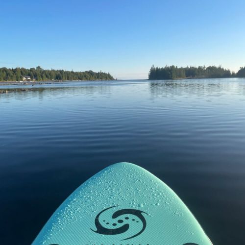 Calm, shallow bay waters ideal for kayaking, paddleboarding, and swimming