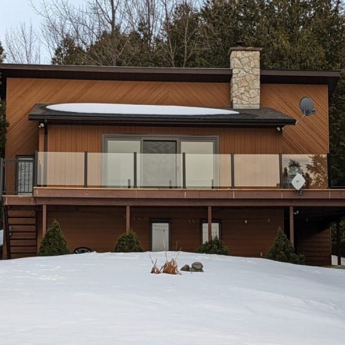 A bright, modern facade under a soft layer of snow—your warm escape from the cold.