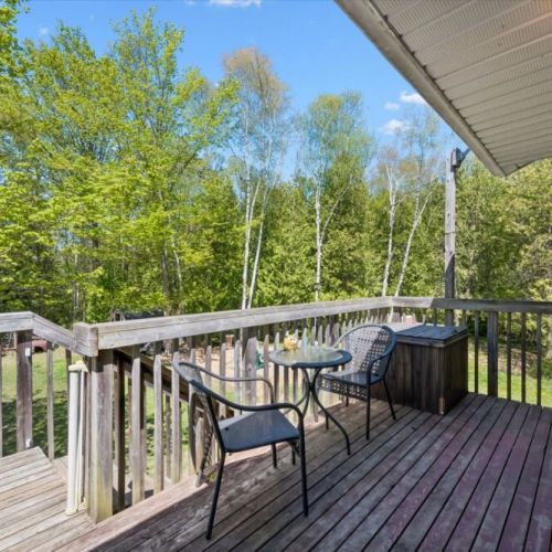 Soak in the hot tub or enjoy a quiet morning coffee on the elevated deck overlooking the property and surrounding forest.