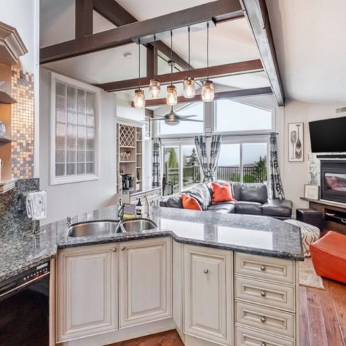 A large kitchen island with double sink and bar seating. A central hub for cooking, dining, and socializing on your getaway.