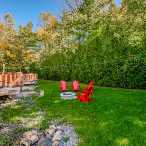 Gather around the fire pit in the backyard for cozy evenings under the stars, with Adirondack chairs ready for your group to enjoy.
