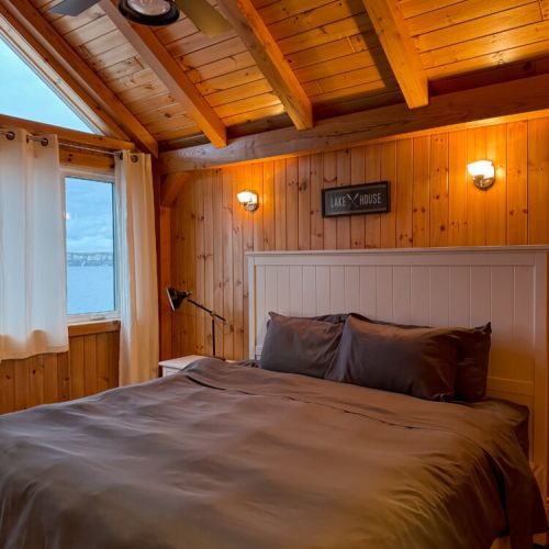 Sleep peacefully in a cozy lake view bedroom with vaulted wood ceilings—perfect for romantic getaways, family vacations, and peaceful retreats.