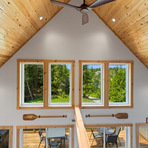 Floor-to-ceiling windows fill the cottage with natural light and beautiful forest views.