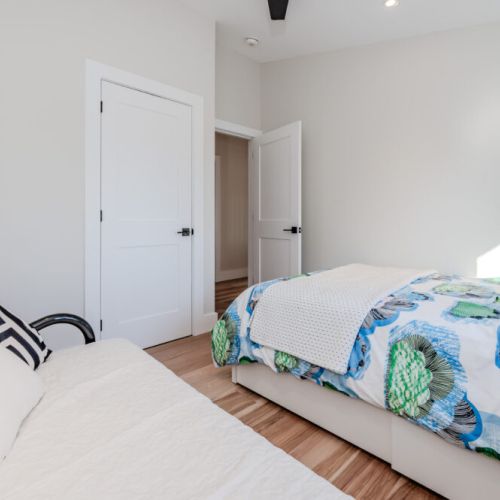 Relax in this bright and cozy bedroom, featuring modern design and plush bedding—perfect for a peaceful night after exploring nearby Bruce Peninsula hiking trails or enjoying lakefront adventures.
