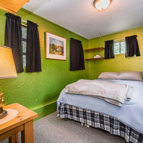 Turn in for the night with the forest-like ambiance of the second Guest bedroom, decorated with rustic touches and artworks that echo the beauty of nature just outside.