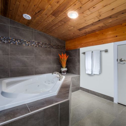The luxurious ensuite features a deep soaker tub and plenty of space to refresh in comfort.