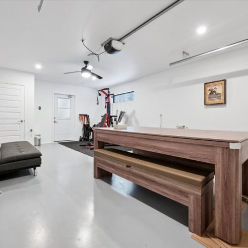 A private games and recreation area featuring a pool table and workout equipment for both active afternoons and laid-back evenings.