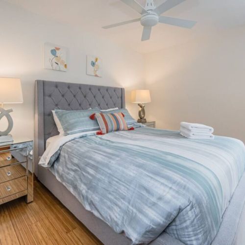Third guest bedroom with comfy queen-sized bed and personal workspace.
