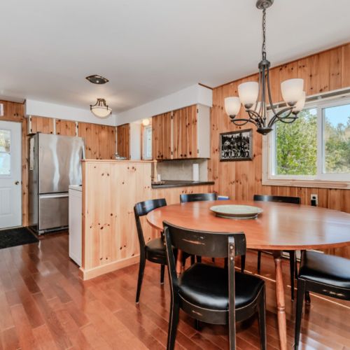Spacious open-concept dining and kitchen area with rustic cottage vibes — your group’s perfect place to reconnect and enjoy vacation living.