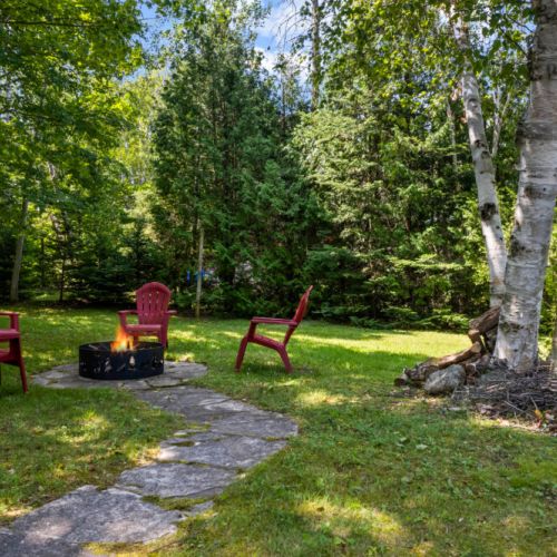 Spend your evenings gathered around the fire pit beneath the trees.