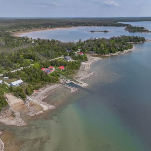 Aerial perspective of Len Cove's prime location along the Lake Huron shoreline—just steps from the water and surrounded by nature.