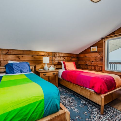 Bright and welcoming, this twin bedroom is ideal for kids or friends on a fun-filled cottage getaway.