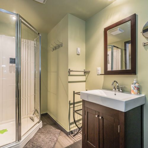 Clean and modern bathroom with walk-in shower for added convenience.