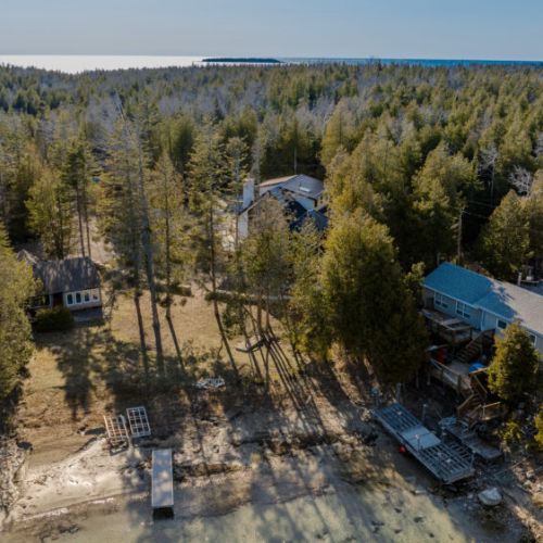 Charming shoreline properties nestled among trees with direct lake access—ideal for peaceful waterfront living or vacation rentals.