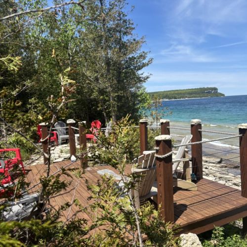 Take in the picturesque lake views from Beeshore's expansive waterside deck, designed for relaxation and enjoyment amidst the beauty of nature