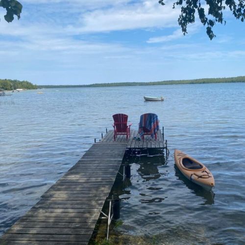 Lounge on your private dock with Adirondack chairs and a kayak ready for adventure—lakefront living at its finest.