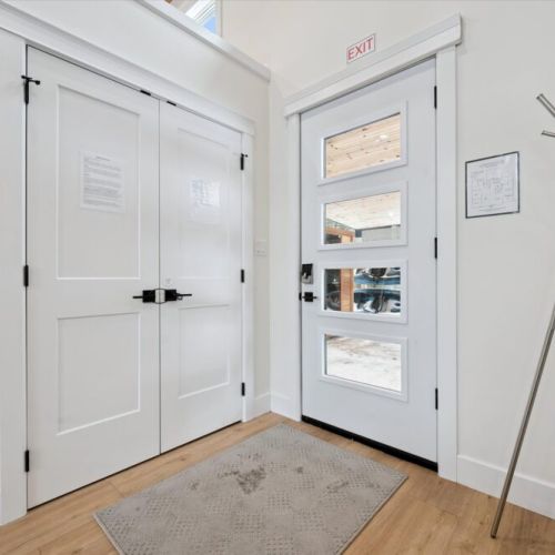 Welcoming entryway with ample storage, bright lighting, and a functional mudroom feel.