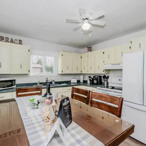 Charming vintage-style kitchen with full-size appliances, microwave, and ample storage—ideal for extended stays and home-cooked vacation meals.
