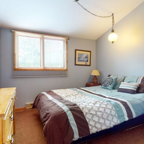 The upper floor guest room features a comfy guest bed and freshly laundered linens.