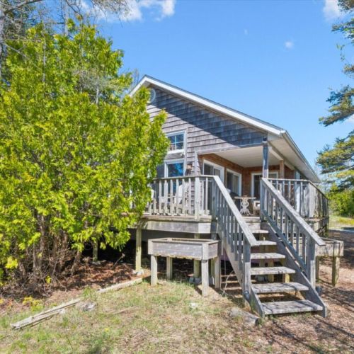 The elevated deck provides easy access to the cottage while creating the perfect spot to enjoy morning coffee, outdoor dining, or an evening under the stars.
