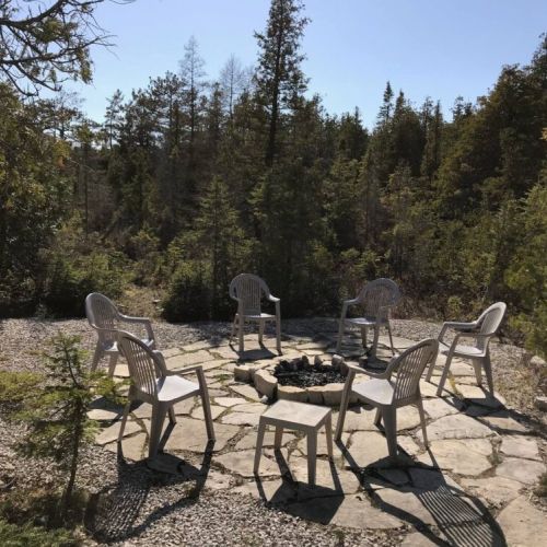 Create memories with family and friends at the private fire pit area, a must-have for your relaxing cottage getaway.