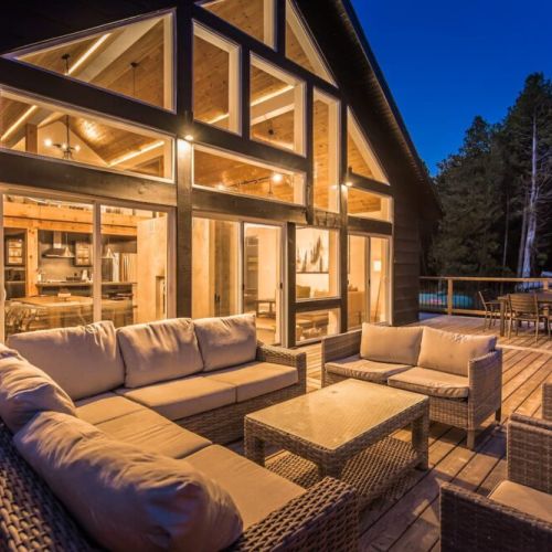 A twighlight show of the back deck with an incredibly comfortable outdoor lounge.
