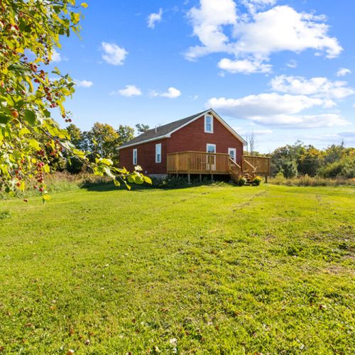 Enjoy the expansive lawn and mature trees that give this historic homestead its peaceful country charm.