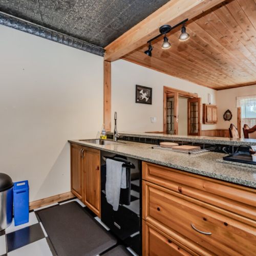 Open-concept kitchen with breakfast bar, modern fixtures, and easy access to the dining area—ideal for group meals and entertaining.