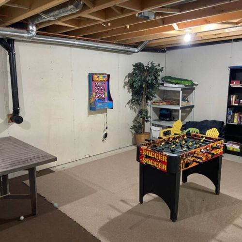 Unwind with foosball, board games, and classic arcade fun in the cozy game room — ideal for family vacations and rainy day activities.