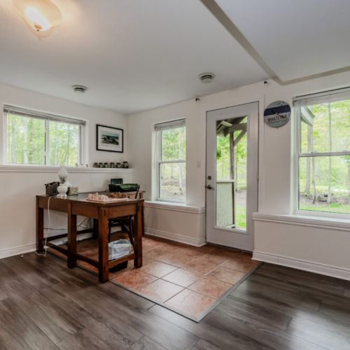 A welcoming workspace in the living area, perfect for board games, crafts, or catching up on some reading, with plenty of natural light streaming in from the windows.