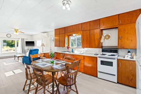 A classic farmhouse kitchen with plenty of cabinetry, counter space and everything close at hand for preparing meals.