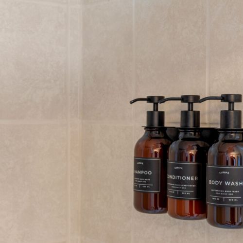 Guest essentials are provided in the shower, including shampoo, conditioner, and body wash.