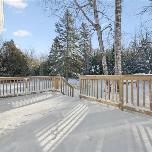 Spacious deck area surrounded by snow and trees for a true Peninsula escape. Great for fresh air, quiet mornings, and watching the seasons change.