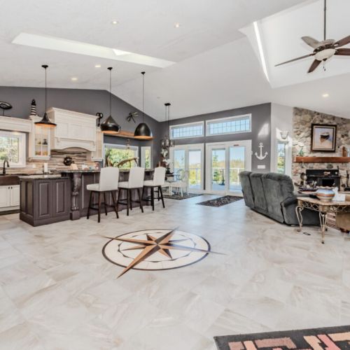 Spacious and stylish lakeside getaway with vaulted ceilings, skylights, and a custom compass inlay. A perfect blend of comfort and charm for family vacations or group retreats.