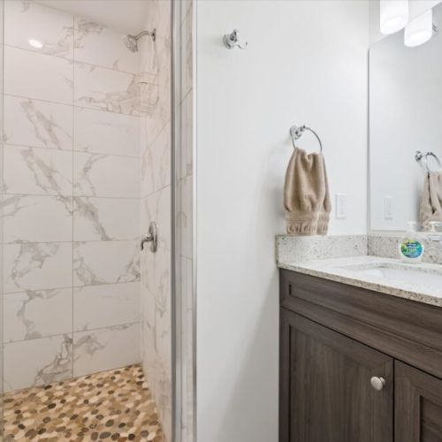 Enjoy the convenience of a modern bathroom featuring a spacious walk-in shower and contemporary finishes.