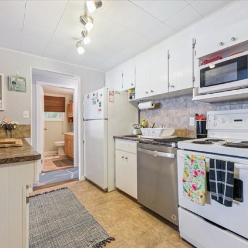 Charming, functional kitchen with ample storage, updated appliances, and a cozy cottage feel — ready for home-cooked meals.