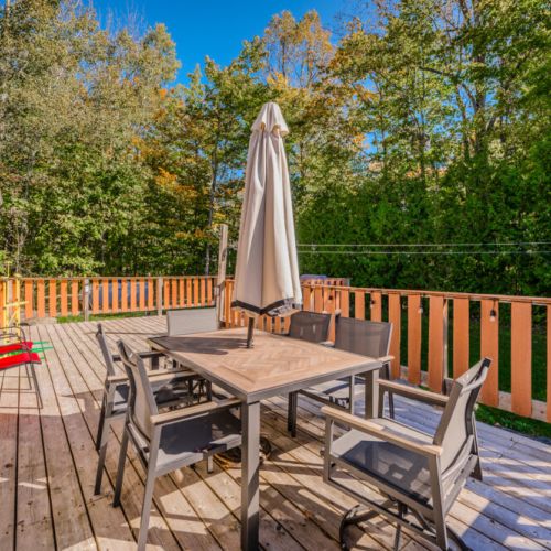 Dine al fresco on the private patio, complete with a shaded outdoor dining setup, perfect for enjoying meals in the fresh air.