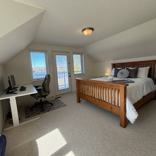 Wake up in a comfortable, spacious bedroom with direct access to a private balcony overlooking Little Lake's serene waters in the second Guest bedroom.