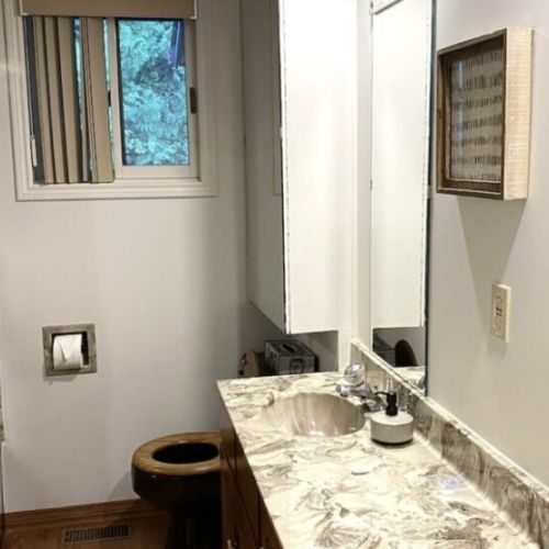 Clean lines and mirrored reflections enhance the pristine bathroom, offering a refreshingly simple space to rejuvenate after a day by Colpoy's Bay.