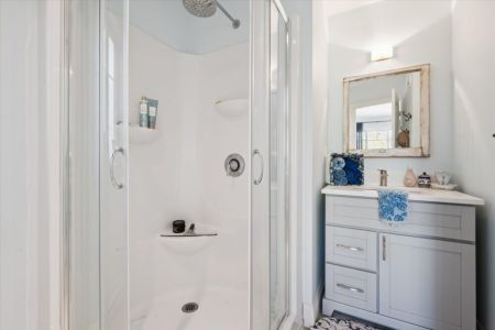 Freshen up in the clean, modern bathroom featuring a walk-in shower and everything you need for a comfortable stay.