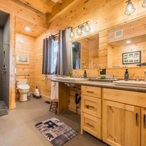 The luxurious 4-piece washroom on the main floor, featuring a spacious walk-in shower and elegant finishes, combines accessibility with high-end comfort.