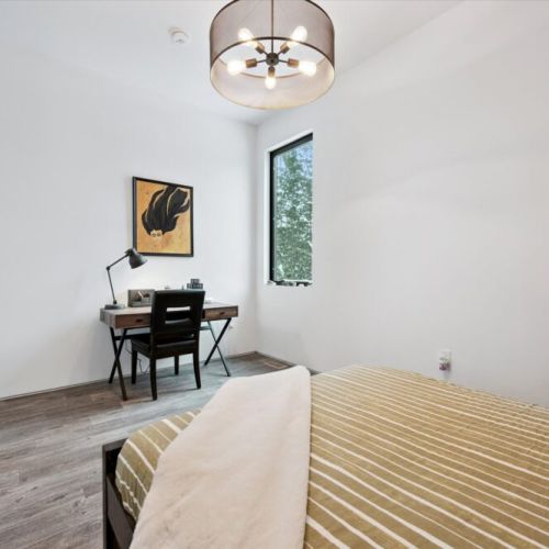 A quiet bedroom workspace paired with forest views, ideal for reading, journaling, or remote work in a calm, distraction-free setting.