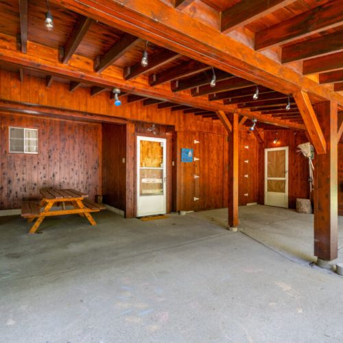 Plenty of space for parking under the awning. The spacious garage area is a testament to the property's history and craftsmanship, where the wood was milled and memories were made.