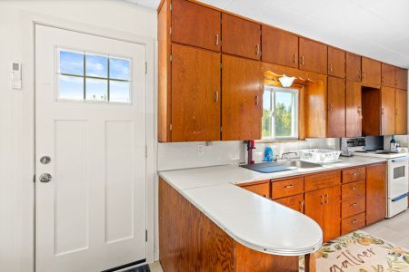 The kitchen offers generous counter space and plenty of cabinetry for easy meal preparation during your stay.