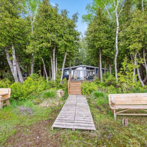 Nestled among mature trees, Summer Side is just steps from the water's edge—your picture-perfect home base for lakeside living.
