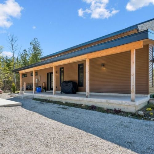 Modern cabin exterior surrounded by nature and beautiful forest scenery.