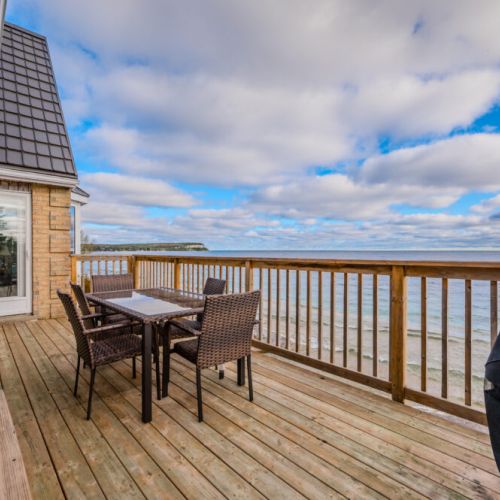 Enjoy intimate meals under the stars in this cozy dining space, conveniently located on the deck by the kitchen for easy access during family gatherings.